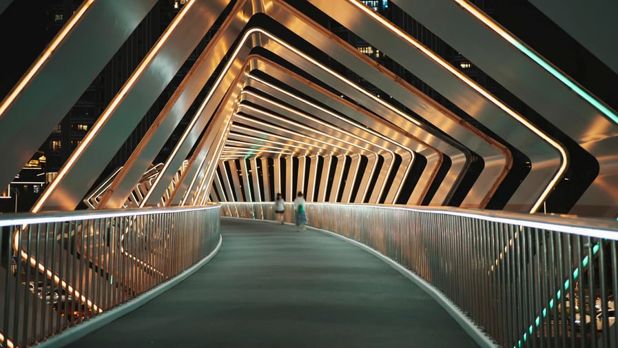 Long bridge with structural roof in repeated patterns