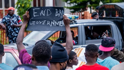 A protester holds up an “End Bad Governance” sign during a demonstration in Nigeria in July 2024.