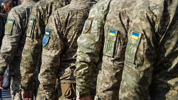 Picture of soldiers in row with Ukraine badges on uniform