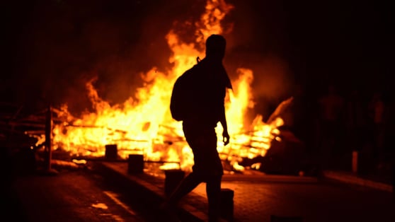 Person standing in front of a fire